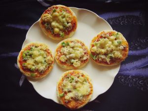 Quick Mini Veg Pizzas are perfect bite sized snacks for parties. Prepare these mini veg pizzas for your next party and surprise your guests!  